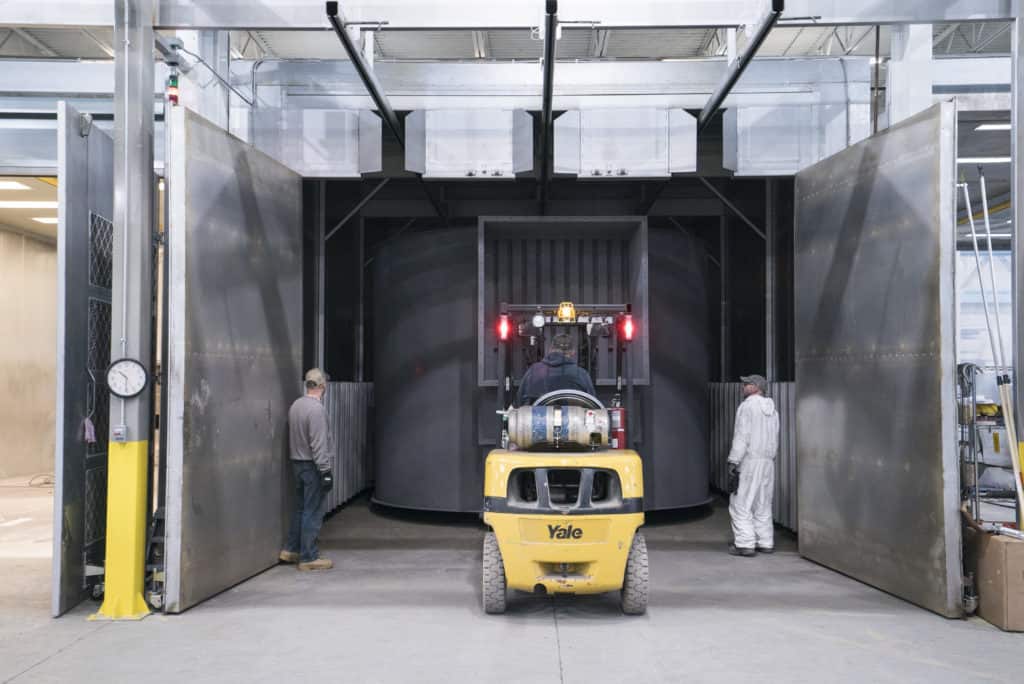 Imperial Systems baghouse being moved inside a powder coating paint booth for a superior finish