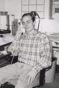 Black and white photo of a younger Jeremiah Wann in his business office