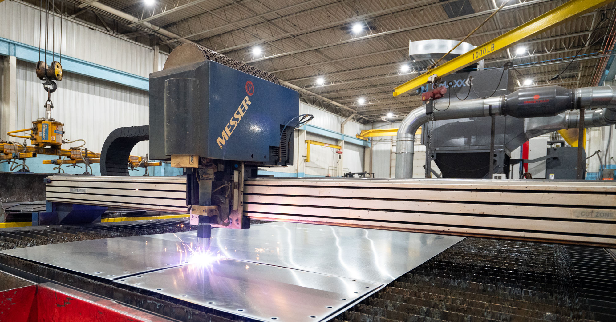 Plasma cutting table in operation with CMAXX capturing its dangerous fumes