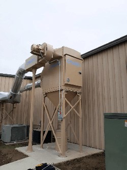 This CMAXX dust collector on a grinder mill machine received custom paint to match the outside of their building.