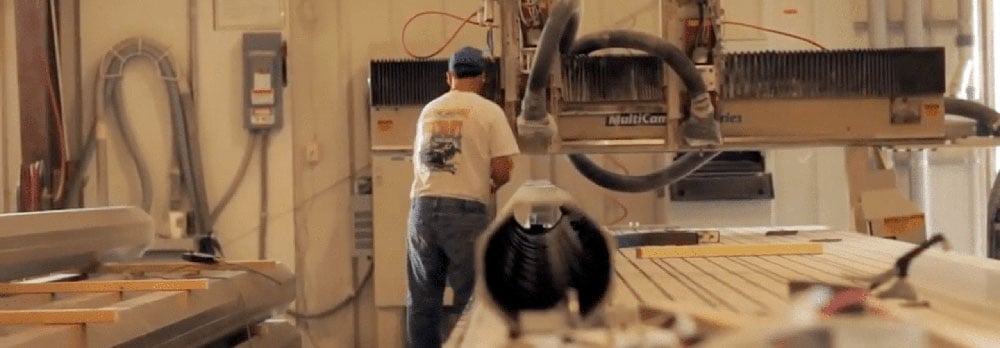 Man in a shop working with fiber reinforced plastic (FRP)