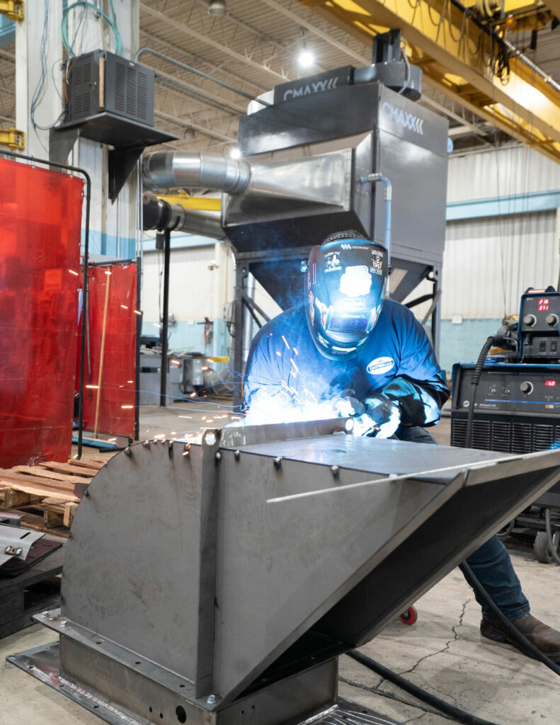 A welder working in a quality work environment, which greatly improves employee retention.