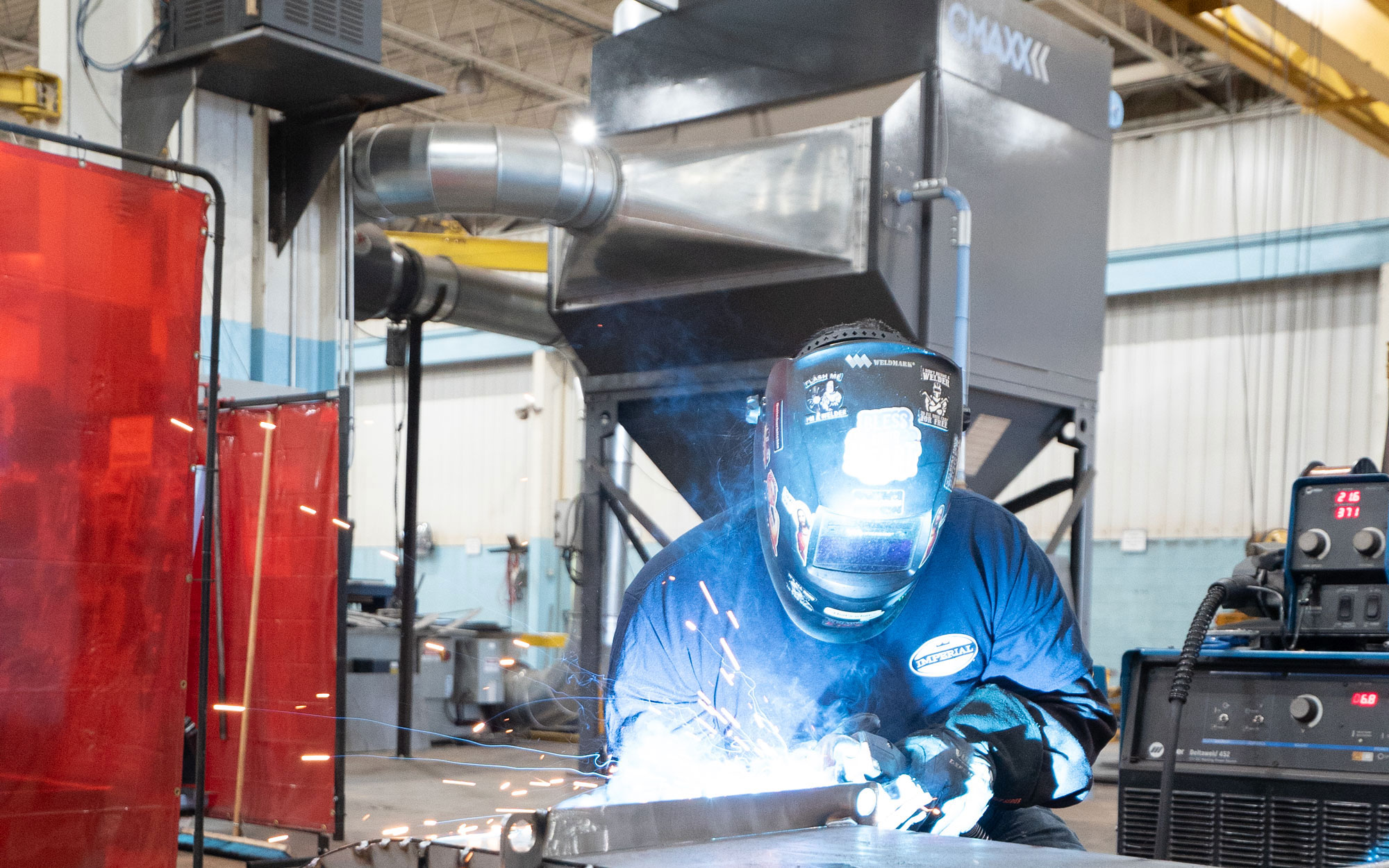 A welder working in a quality work environment, which greatly improves employee retention.